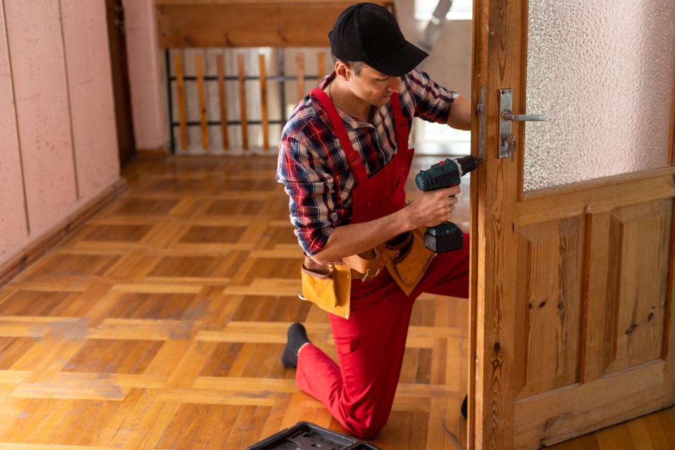 Technician working on wooden door